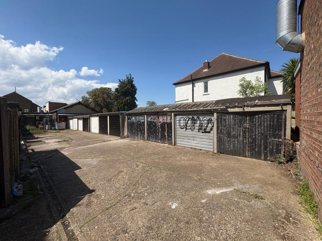 Lot: 17 - FOUR FREEHOLD GARAGES IN A COMPOUND - View of all garages in compound from driveway